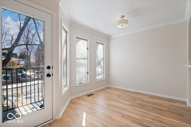 entryway featuring crown molding and light hardwood / wood-style floors