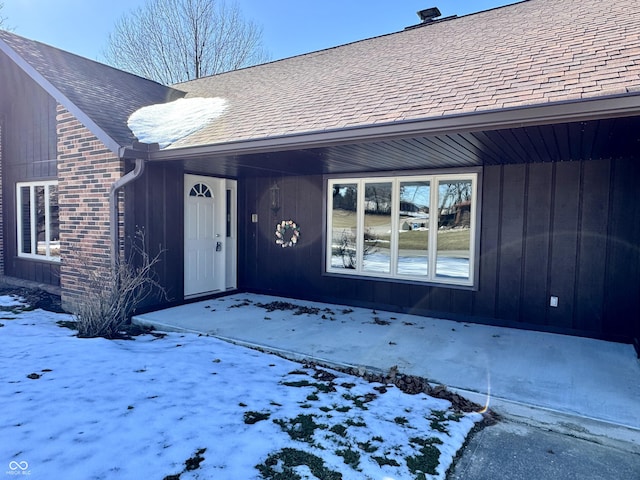 view of snow covered property entrance