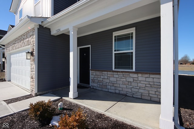 entrance to property with a garage and covered porch