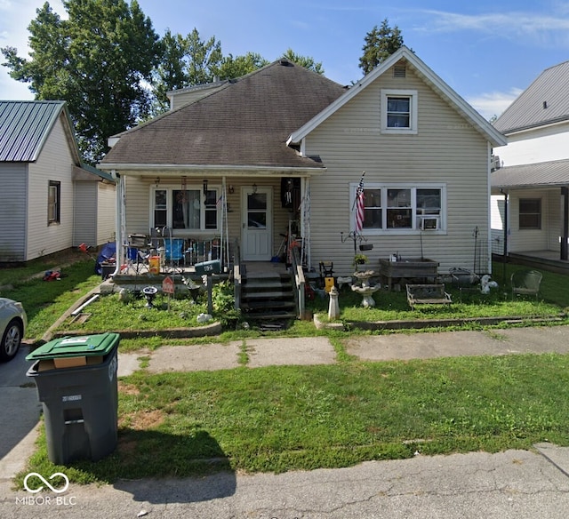 view of front of house with a front yard and covered porch