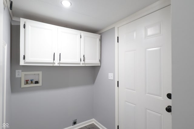 laundry room with electric dryer hookup, hookup for a washing machine, and cabinets