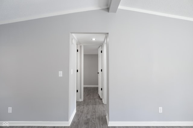 hallway featuring hardwood / wood-style flooring and lofted ceiling with beams