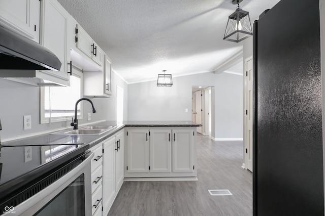 kitchen with white cabinetry, sink, pendant lighting, and kitchen peninsula