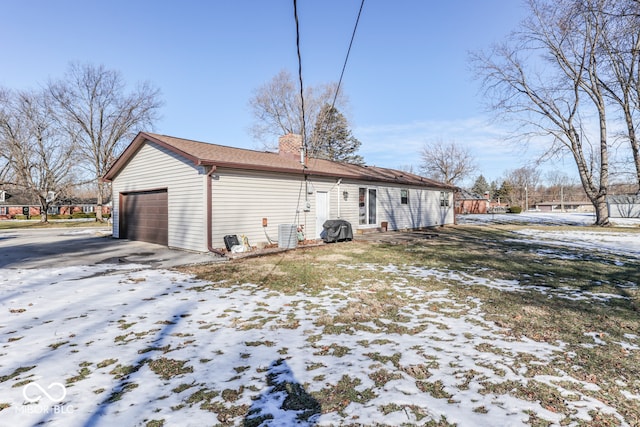 snow covered house with a garage