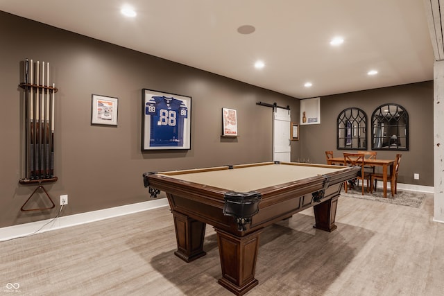 recreation room featuring billiards, a barn door, and light wood-type flooring