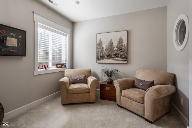 living area featuring light colored carpet