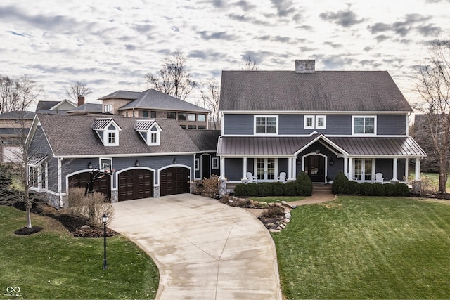 view of front facade with a garage, a front lawn, and a porch