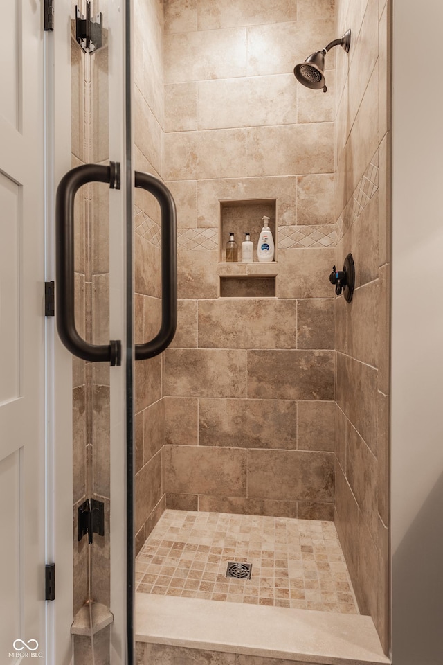 bathroom featuring a shower with door