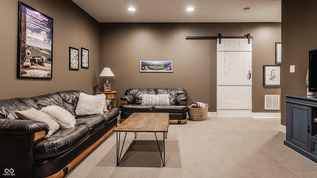 carpeted living room featuring a barn door