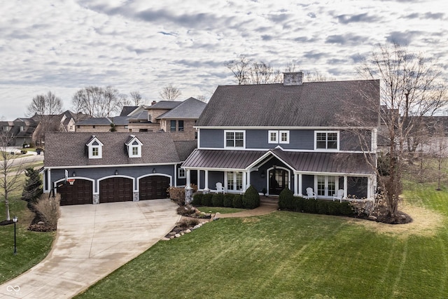 view of front of home with a garage, a front yard, and covered porch