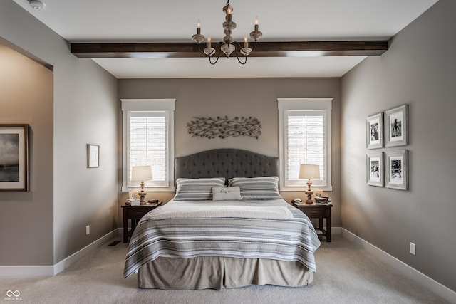 carpeted bedroom with multiple windows, an inviting chandelier, and beam ceiling