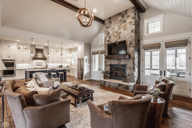 living room featuring dark wood-type flooring, beam ceiling, high vaulted ceiling, and a stone fireplace