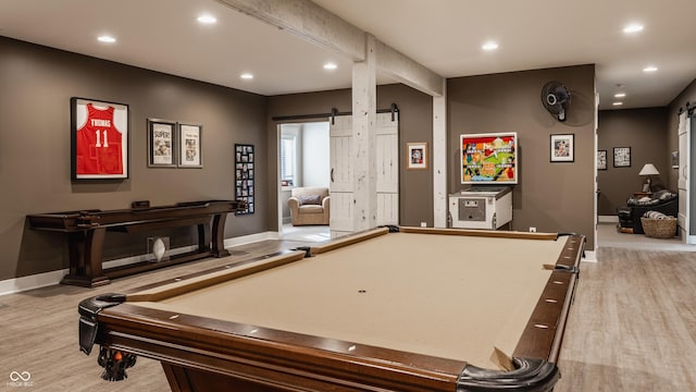 recreation room with a barn door, light wood-type flooring, and billiards