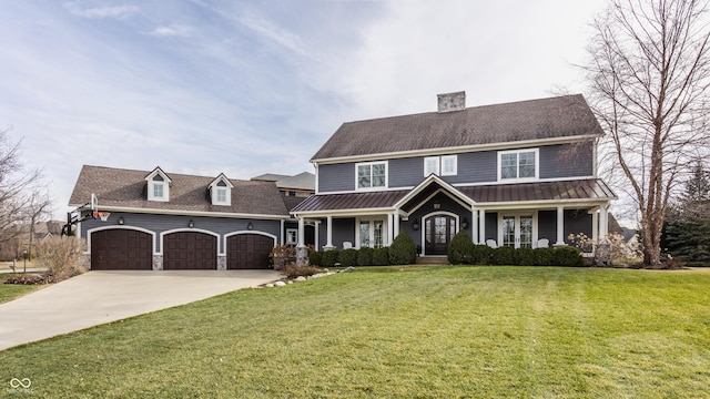 view of front of house with a porch, a garage, and a front lawn