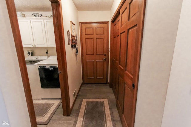 corridor with washer and dryer and a textured ceiling