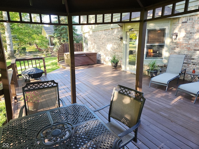 wooden terrace featuring a hot tub