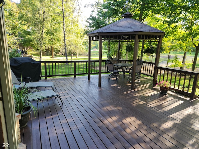 wooden terrace featuring a yard, a gazebo, and grilling area