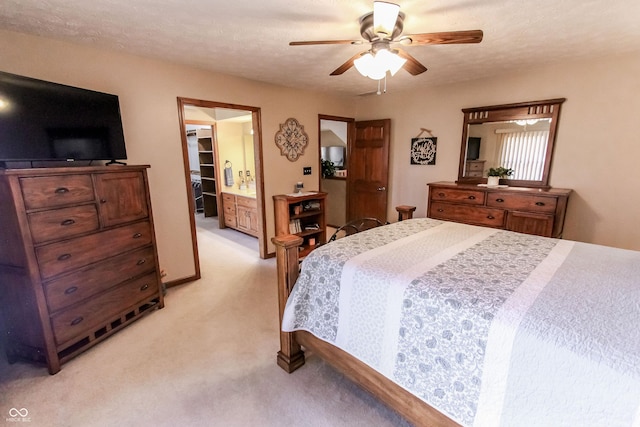 carpeted bedroom with ceiling fan and a textured ceiling