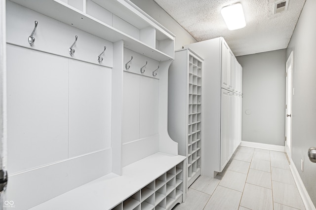 mudroom featuring a textured ceiling