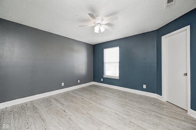 unfurnished room with ceiling fan, light hardwood / wood-style floors, and a textured ceiling