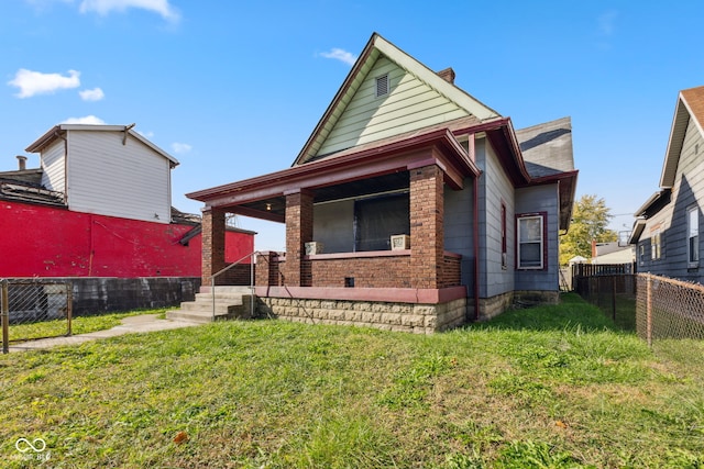 view of front of house featuring a front lawn and covered porch