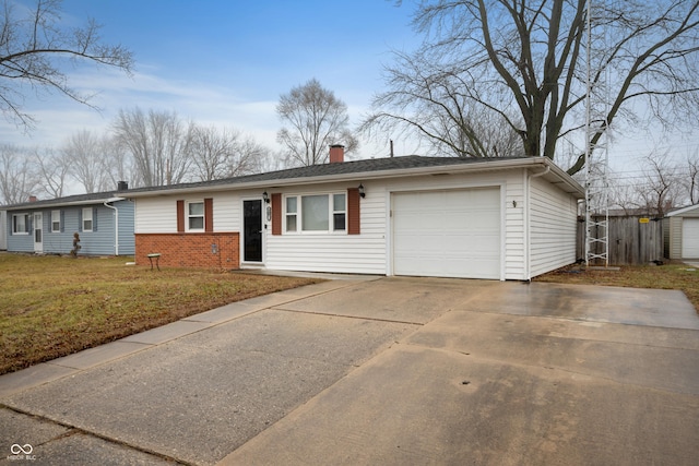 single story home with a garage and a front lawn