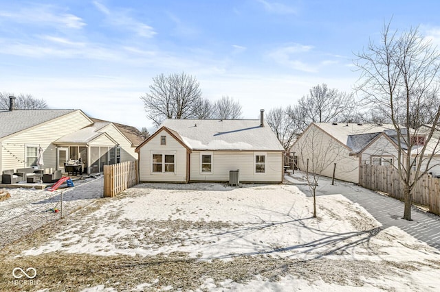 view of snow covered rear of property