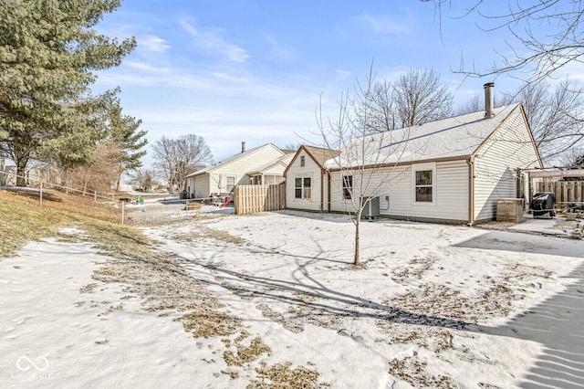 view of snow covered rear of property