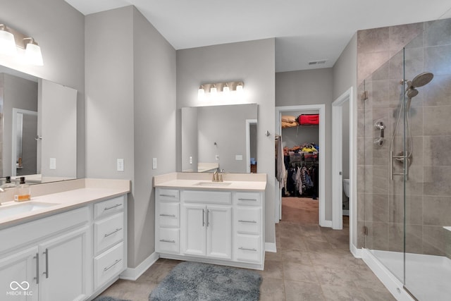 bathroom with walk in shower, tile patterned floors, vanity, and toilet