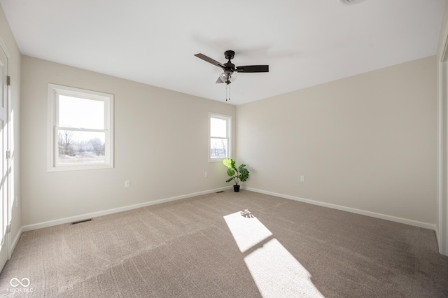 unfurnished room featuring ceiling fan and light colored carpet