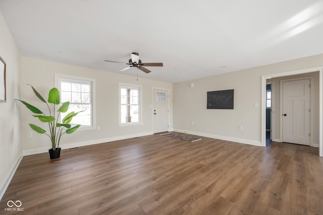 entryway with dark hardwood / wood-style floors and ceiling fan