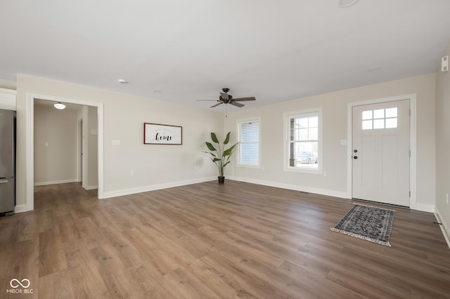 foyer with hardwood / wood-style flooring and ceiling fan