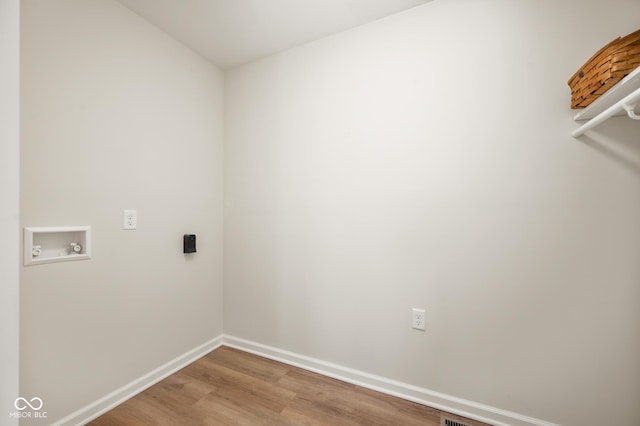 laundry area with hookup for a washing machine and hardwood / wood-style floors