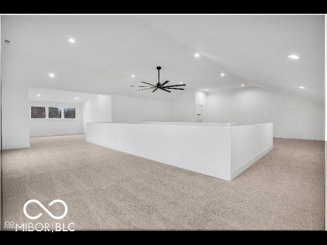 interior space featuring lofted ceiling and ceiling fan