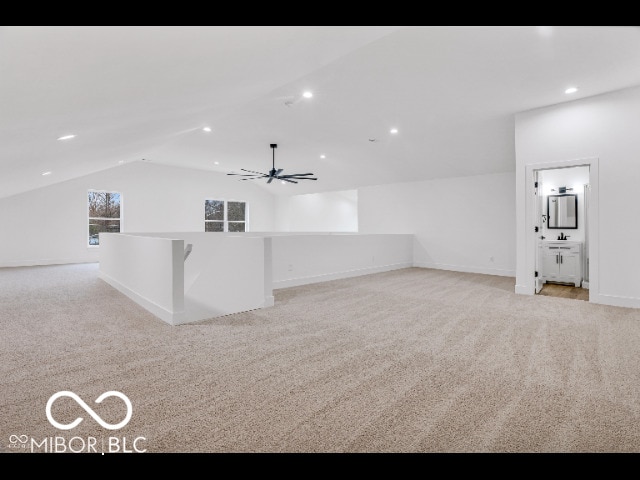 bonus room featuring ceiling fan, light colored carpet, and vaulted ceiling