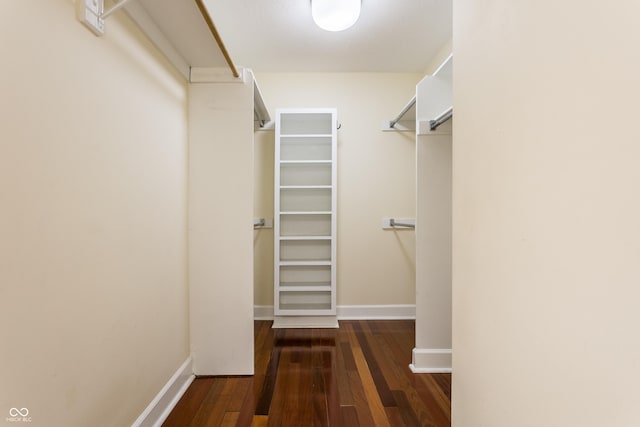 walk in closet with dark hardwood / wood-style floors