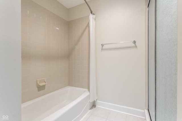 bathroom with tiled shower / bath combo and tile patterned floors