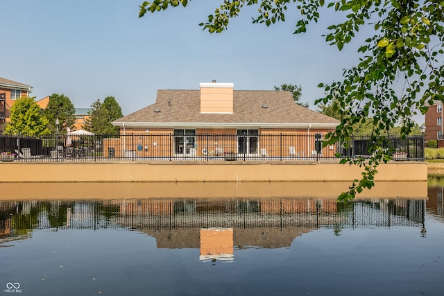 back of property featuring a water view