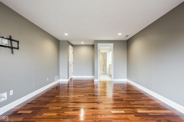 spare room with dark hardwood / wood-style floors