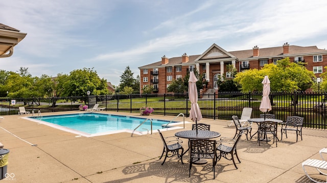 view of swimming pool with a patio