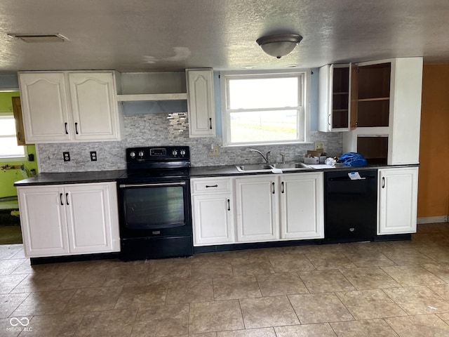 kitchen with white cabinetry, plenty of natural light, sink, and black appliances