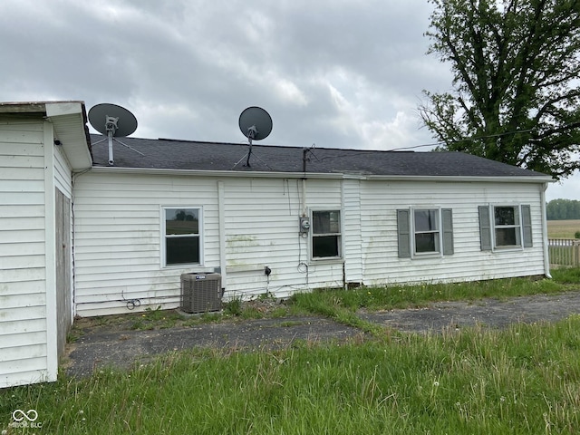 rear view of house featuring central AC unit