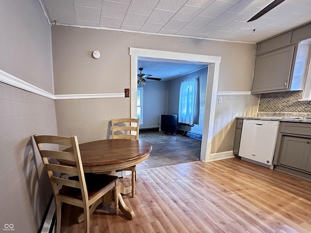 dining space with ceiling fan and light wood-type flooring