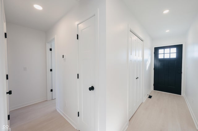 corridor with light wood-type flooring