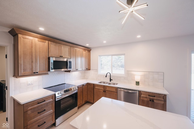 kitchen featuring stainless steel appliances, tasteful backsplash, and sink