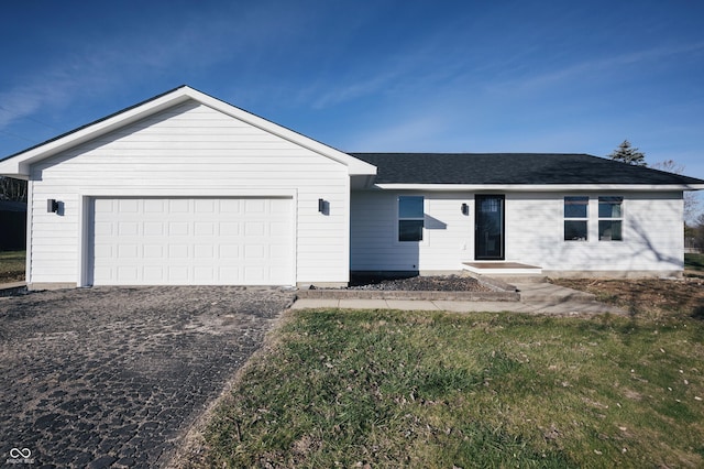 single story home with a garage and a front yard