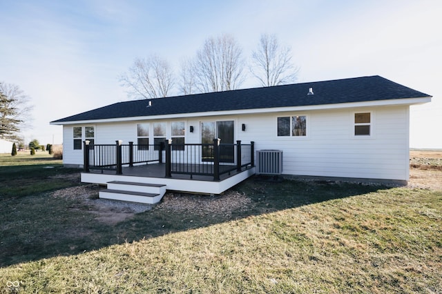 rear view of property featuring a wooden deck, a yard, and central AC unit