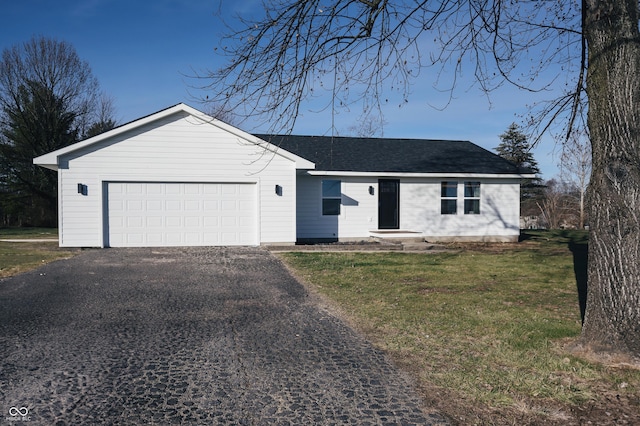 ranch-style house featuring a garage and a front yard