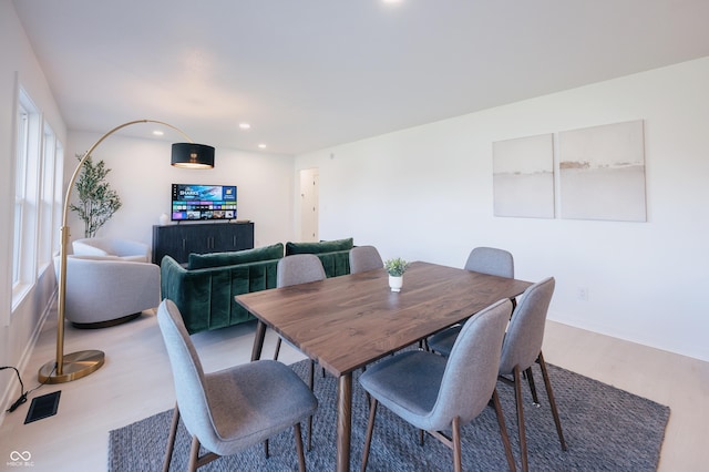 dining space with hardwood / wood-style flooring