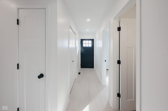 hallway with light hardwood / wood-style flooring